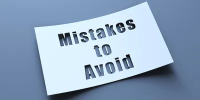 what paper on a grey background with the words mistakes to avoid cut out of the paper