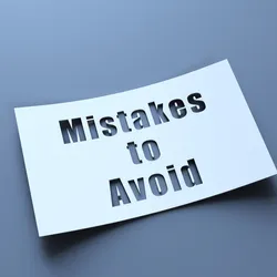 what paper on a grey background with the words mistakes to avoid cut out of the paper