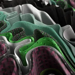 Many layers of winding multicolored fabric create an abstract wavy pattern