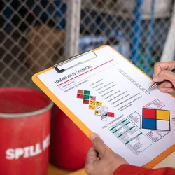 safety inspector with chemical safety checklist emphazing the importance of chemical spill prevention and safety in the laboratory
