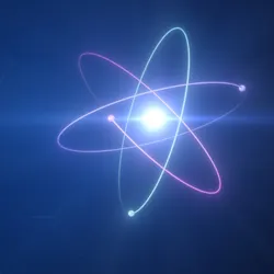 A glowing blue nucleus of an atom surrounded by electrons and protons orbiting it