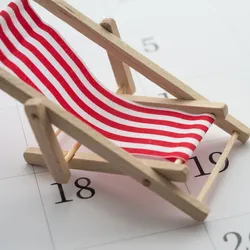 red and white striped beach chair sitting on top of a calendar illustrating the concept of summer vacation scheduling
