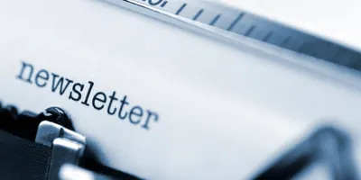 close view of typewriter with the text "newsletter" on the page suggesting the importance of an employee newsletter in building a good work culture