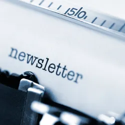 close view of typewriter with the text "newsletter" on the page suggesting the importance of an employee newsletter in building a good work culture