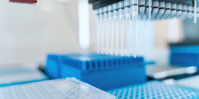 automated liquid handling system dispensing safely into multiple blue well-plates in a robotic workstation