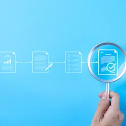 image of techical document icons on a blue background. a hand holds a mignifying glass over one of them suggesting the concept of in-house vs external quality managwment