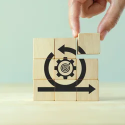 wooden blocks forming a symbol illustrating continous improvement a cope of both Lean management and Six Sigma
