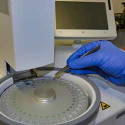 Scientist analyzing a sample by DSC in a chemistry laboratory, TGA and DSC are critical in thermal analysis