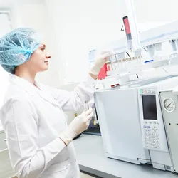 laboratory technician working with gas chromatography system
