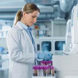 Female researcher working in a modern lab where affinity and size exclusion chomatography is performed