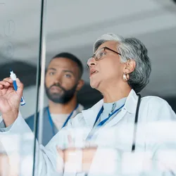 A senior lab manager coaches some younger employees