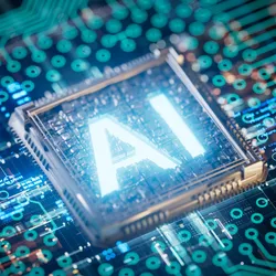 A CPU on a motherboard glowing with the letters AI emblazoned on top