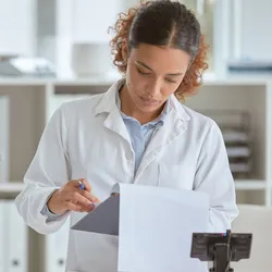 Scientists in the lab writing on a clipboard