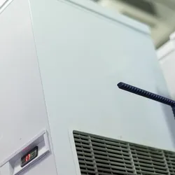 Close-up of a laboratory chiller unit with digital temperature display and ventilation panel