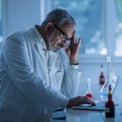 lab employee looking tired and overworked