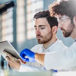 2 researchers workingwith a tablet computer focused on analytical method development