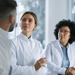 Medical experts talking while working on medical research in laboratory.