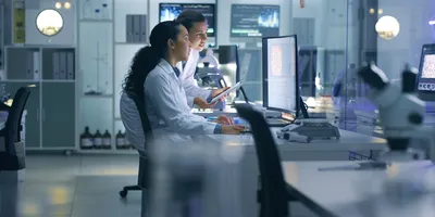 Two scientists communicating in the lab.