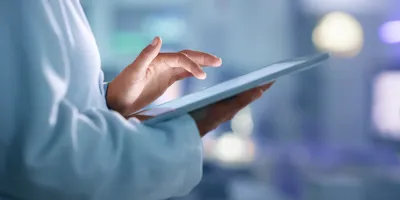 Scientist holding a tablet, symbolic of a paperless lab.
