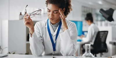 Scientist in the lab looking stressed from burnout.