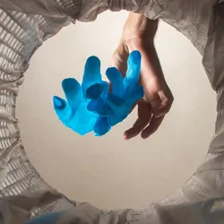 image of laboratory gloved being dropped into a waste bin illustrating the significance of medical waste manangement 