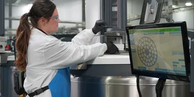 Technician accessing automated cold storage system with digital inventory interface.