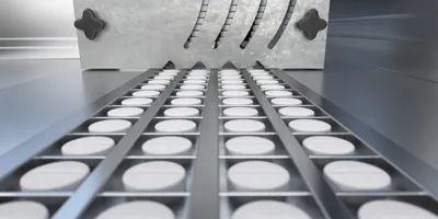White tablets produced in a GMP facility represent validated pharmaceutical workflows supported by USP monographs and quality control methods