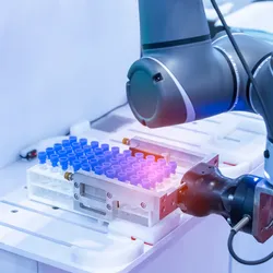 Robotic arm handling test tubes in an automated laboratory system for lab automation processes.