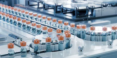 pharmaceutical vials on a conveyor system illustrating continuous manufacturing in pharmaceutical processing