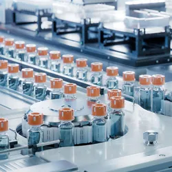 pharmaceutical vials on a conveyor system illustrating continuous manufacturing in pharmaceutical processing