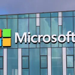 A wide shot of the Microsoft sign outside a glass-walled office building