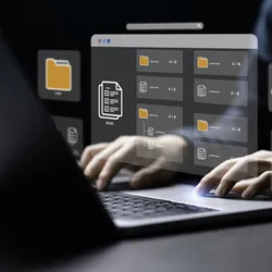 Person typing on a laptop with digital file and folder icons projected above the keyboard, representing data management and digital workflows in a laboratory information management system (LIMS).