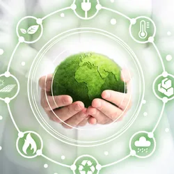 Hands holding a green globe symbolizing sustainability in lab operations