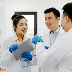 Three scientists collaborating in an environmental testing lab