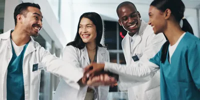 A purpose-driven lab team motivates each other before a shift with a team meeting