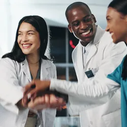 A purpose-driven lab team motivates each other before a shift with a team meeting