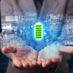 Hands holding a digital battery icon and data graphs, representing next-generation battery technologies.