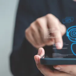 Person interacting with a smartphone interface displaying a chatbot icon and the phrase “Can I help you?”, symbolizing the use of AI tools in scientific or lab environments.