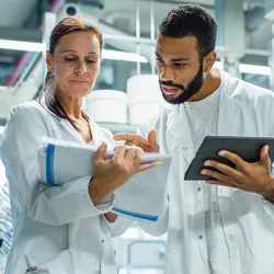 Two lab professionals collaborating on quality-first practices