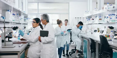 Laboratory setting with multiple researchers emphasizing the importance of acoustic control.