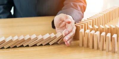 Dominion blocks on a table, illustrating the concept of leadership avalanche.
