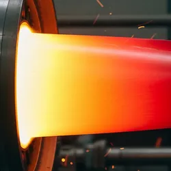 A close-up of a glowing, red-hot jet engine turbine blade, representing high-temperature alloys and superalloys in aerospace engineering.