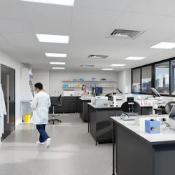 Male scientist walking through modern lab space
