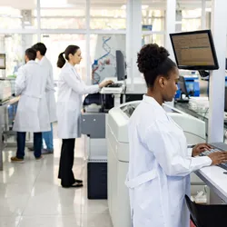 Laboratory scene showing researchers working on cell therapy development.