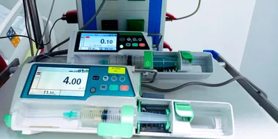 Medical infusion pump for precise delivery of drugs into the bloodstream. Syringe pump in an intensive care unit.