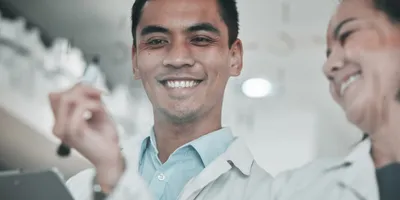 Smiling laboratory professionals illustrating workplace leadership