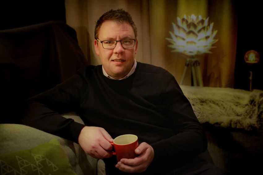Graham Flynn sitting on chair with coffee mug Graham Flynn sitting on chair with coffee mug