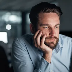 Man looking bored at work, highlighting employee engagement issues