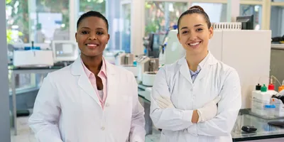 Radiation safety officer and lab manager in equipment-filled lab