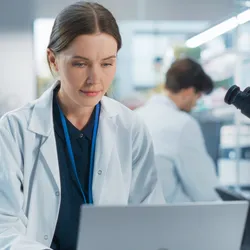 Scientist using a laboratory information management system (LIMS) in a modern laboratory